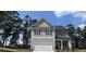 Charming two-story home with gray siding, a covered porch, and an attached two-car garage at 45 Heyman Dr, Covington, GA 30016