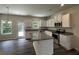 Modern kitchen features white cabinets, stainless steel appliances, and a granite island with a breakfast bar at 45 Heyman Dr, Covington, GA 30016