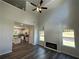 Open-concept living room with high ceilings, wood floors, fireplace, and abundant natural light from large windows at 45 Heyman Dr, Covington, GA 30016