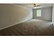 Spacious main bedroom featuring neutral carpeting, ample natural light, and a contemporary ceiling fan at 45 Heyman Dr, Covington, GA 30016