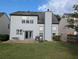 Expansive backyard featuring a well-manicured lawn, a patio, and a full privacy fence at 640 Dahoma Trl, Woodstock, GA 30188