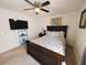 Cozy bedroom with carpeting features a full-size bed and a ceiling fan for added comfort at 640 Dahoma Trl, Woodstock, GA 30188