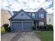Charming two-story home with a two-car garage, manicured lawn, and tasteful brick and siding combination at 640 Dahoma Trl, Woodstock, GA 30188
