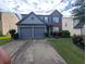 Charming two-story home with a well-manicured lawn and a two-car garage in a suburban neighborhood at 640 Dahoma Trl, Woodstock, GA 30188
