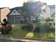 Charming two-story home with lush landscaping, blooming flowers, and a well-manicured lawn at 640 Dahoma Trl, Woodstock, GA 30188