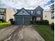 Charming two-story home with a well-manicured lawn and a two-car garage in a suburban neighborhood at 640 Dahoma Trl, Woodstock, GA 30188