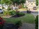 Inviting front yard with meticulously maintained landscaping, flowerbeds, and healthy green grass at 640 Dahoma Trl, Woodstock, GA 30188