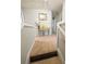 View of hallway at top of stairs, showing a table with decorative vases, mirror and neutral walls at 640 Dahoma Trl, Woodstock, GA 30188