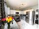 Kitchen featuring white and gray cabinets, stainless appliances and marble floors at 640 Dahoma Trl, Woodstock, GA 30188