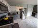 Well-lit kitchen featuring stainless appliances, white cabinets, and marble floors at 640 Dahoma Trl, Woodstock, GA 30188