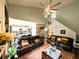 Open-concept living room featuring a fireplace, ceiling fan, and access to the kitchen at 640 Dahoma Trl, Woodstock, GA 30188