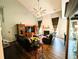 Spacious living room with fireplace, ceiling fan, hardwood floors, and display cabinet at 640 Dahoma Trl, Woodstock, GA 30188