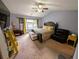Spacious main bedroom with carpeting features a king-size bed and a ceiling fan for added comfort at 640 Dahoma Trl, Woodstock, GA 30188