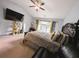 This is the main bedroom boasting plush carpeting, a ceiling fan, and natural light at 640 Dahoma Trl, Woodstock, GA 30188