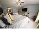 Relaxing main bedroom offering plush carpeting, a ceiling fan, and easy access to the ensuite bathroom at 640 Dahoma Trl, Woodstock, GA 30188