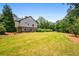 A large, beautifully landscaped backyard with a well-maintained lawn at 150 Seals Rd, Dallas, GA 30157