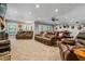 Spacious basement with comfortable leather couches, a ceiling fan, and ample natural light from large windows for relaxation at 150 Seals Rd, Dallas, GA 30157