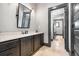 Well-lit bathroom featuring a granite countertop, cabinetry, and neutral tile floors at 150 Seals Rd, Dallas, GA 30157