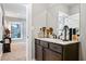 Stylish powder room features marble counters, dark wood cabinets and large mirror at 150 Seals Rd, Dallas, GA 30157