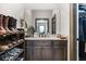 Bathroom vanity featuring countertop space, storage cabinets, and a display of footwear next to a closet at 150 Seals Rd, Dallas, GA 30157
