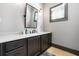 Bathroom vanity with a marble countertop, dark cabinets, and a modern mirror fixture at 150 Seals Rd, Dallas, GA 30157