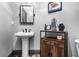 Half bath with unique decor, pedestal sink, and wooden cabinet at 150 Seals Rd, Dallas, GA 30157
