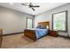 Spacious bedroom with neutral colored carpet, trim, and two bright windows at 150 Seals Rd, Dallas, GA 30157