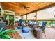 Expansive covered deck with ceiling fans, wicker furniture, comfortable seating, and scenic views for outdoor entertaining at 150 Seals Rd, Dallas, GA 30157