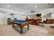 Finished basement game room with pool table, leather couches, and a fireplace with built-in shelving for entertainment at 150 Seals Rd, Dallas, GA 30157