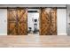 Home gym with barn doors and hardwood floors at 150 Seals Rd, Dallas, GA 30157