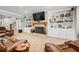 Basement living room with cozy fireplace, built-in shelving, leather furniture, and a flat screen TV for a relaxing space at 150 Seals Rd, Dallas, GA 30157