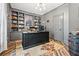 Home office with custom built-in shelving and a dark wood desk on decorative rug at 150 Seals Rd, Dallas, GA 30157