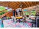 A covered outdoor dining area with stylish furniture and a ceiling fan at 150 Seals Rd, Dallas, GA 30157