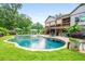Beautiful backyard pool with surrounding patio and lush landscaping at 150 Seals Rd, Dallas, GA 30157