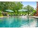 Inviting backyard pool with in-pool loungers, patio, and verdant surroundings at 150 Seals Rd, Dallas, GA 30157