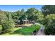Aerial view of lush front yard, gated entrance, and large brick home with mature trees at 402 Clyde Ct, Mcdonough, GA 30252