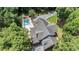 An aerial view of a home and pool surrounded by lush trees at 402 Clyde Ct, Mcdonough, GA 30252