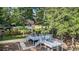 Spacious backyard with a multi-tiered deck, lush landscaping, and mature trees at 402 Clyde Ct, Mcdonough, GA 30252