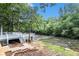 Scenic backyard with a multi-level deck overlooking a tranquil river surrounded by lush greenery at 402 Clyde Ct, Mcdonough, GA 30252