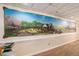 Basement hallway featuring a custom mural and hardwood floors at 402 Clyde Ct, Mcdonough, GA 30252