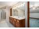 Spacious bathroom featuring a shower and double sink vanity with cabinet storage at 402 Clyde Ct, Mcdonough, GA 30252