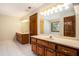 Bathroom boasts dual vanities with wooden cabinets and drawers with tiled flooring at 402 Clyde Ct, Mcdonough, GA 30252