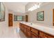 Spacious bathroom featuring an extra long vanity, jetted tub, windows, and tile flooring at 402 Clyde Ct, Mcdonough, GA 30252