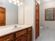 Bathroom featuring a spacious vanity with white countertop, wood cabinetry, and tiled floor at 402 Clyde Ct, Mcdonough, GA 30252