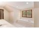 Bright bathroom with a soaking tub under a window with forest views, features and sinks at 402 Clyde Ct, Mcdonough, GA 30252