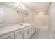 Bright bathroom featuring a large vanity with ample counter space, a full-sized mirror, and a shower-tub combo at 402 Clyde Ct, Mcdonough, GA 30252