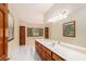 Bright bathroom with dual vanity, wood cabinets, soaking tub, and natural light at 402 Clyde Ct, Mcdonough, GA 30252