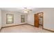 Neutral bedroom has carpet, natural light from windows, and a closet with an open door at 402 Clyde Ct, Mcdonough, GA 30252