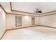 Large bedroom with neutral walls, white carpet, wood trim and ceiling fan at 402 Clyde Ct, Mcdonough, GA 30252