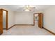 Spacious bedroom with two open doors, carpet, and neutral walls with baseboard trim at 402 Clyde Ct, Mcdonough, GA 30252